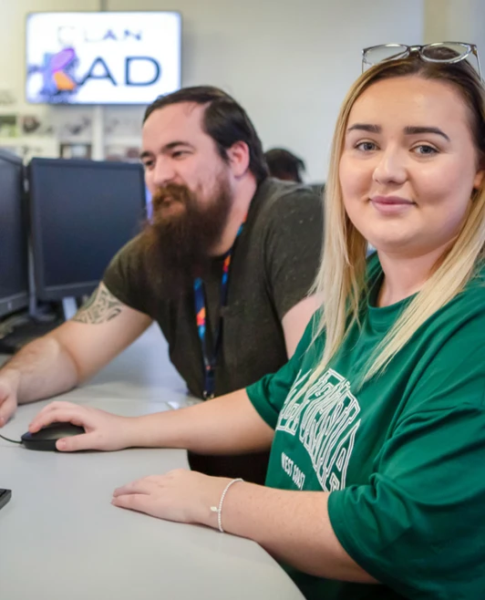 A student and a lecturer working together on a 3D modeling project, with a detailed CAD design displayed on the computer screen. A student and a lecturer working together on a 3D modeling project, with a detailed CAD design displayed on the computer screen.